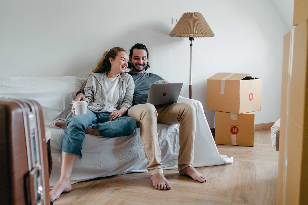 happy-couple-spending-time-together-on-sofa-after-moving-4245928